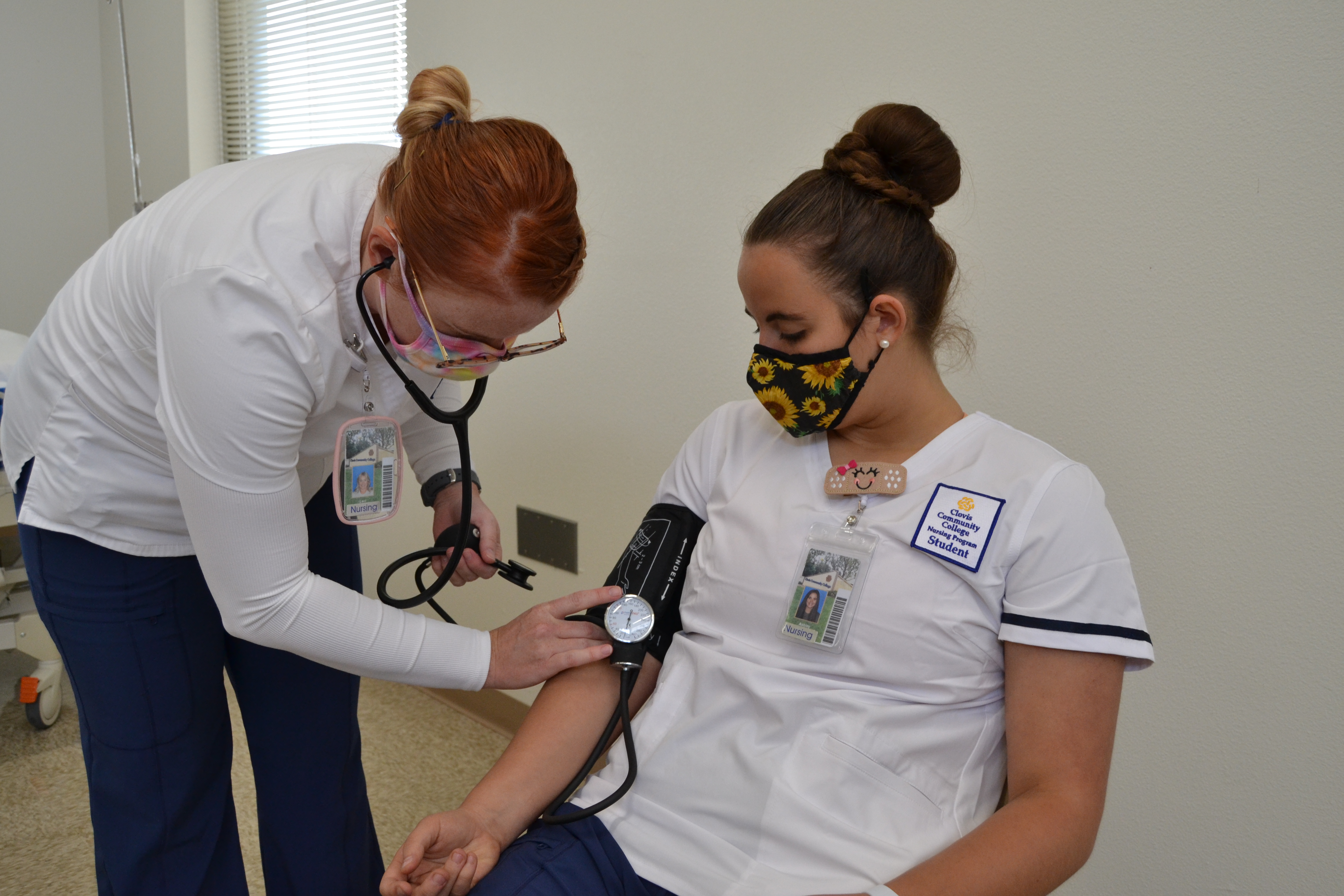 allied health nursing teacher taking blood pressure on student